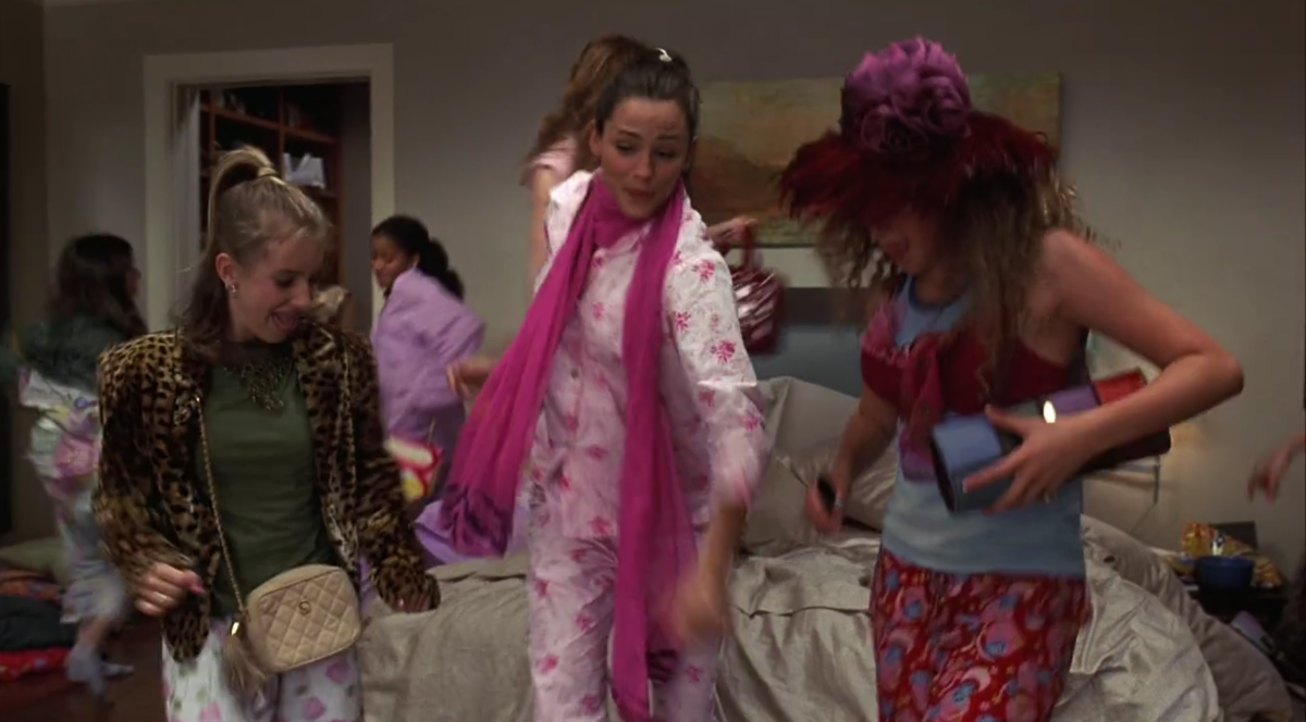 Jenna and a bunch of young girls are in pajamas dancing in a bedroom