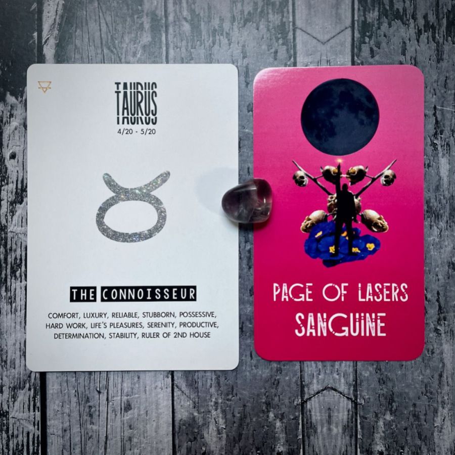 Page of Lasers Sanguine is a pink card with a collage of skulls hanging off of a tree, next to it is a card that says Taurus is the connoisseur