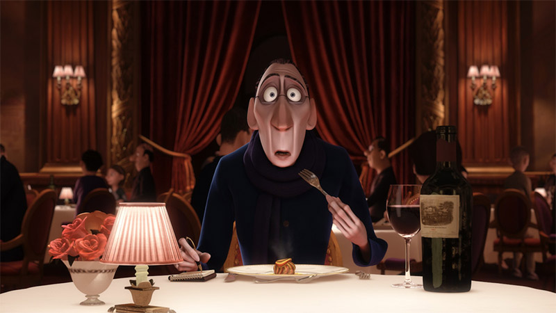 Anton Ego eats a piece of ratatouille and his eyes are huge