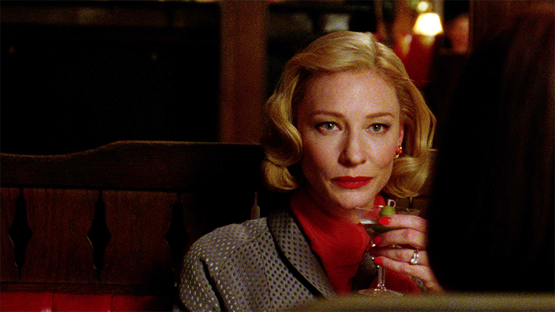 Carol Aird drinks a martini and smirks