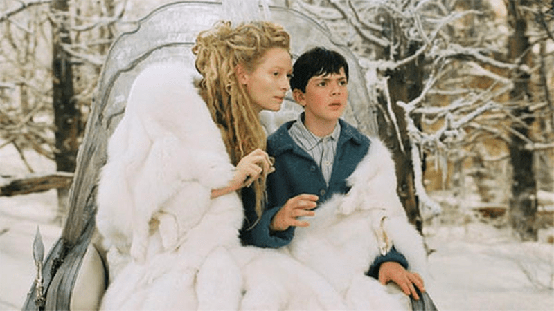 The White Witch wraps her cloak around Edmund