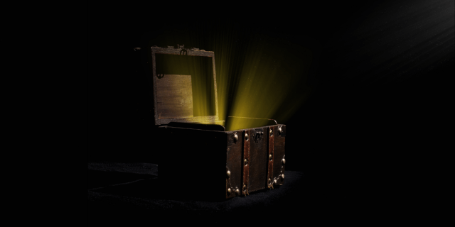 A treasure chest with glowing yellow light coming out of it, set against a black background.