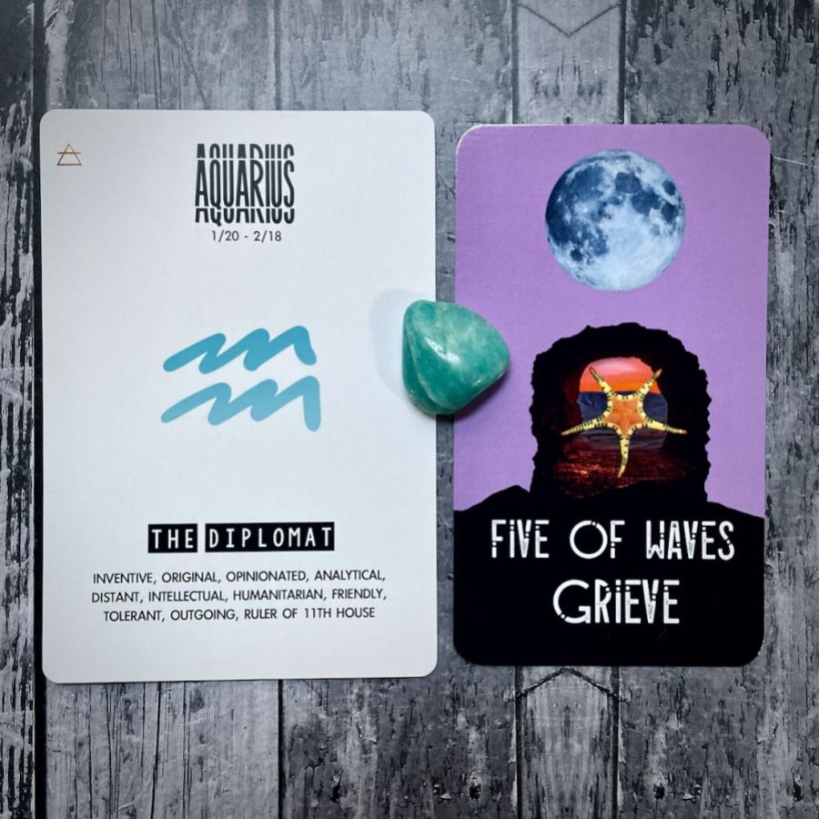 The Five of Waves Grieve is a lavender card with a bright moon and a collage of a orange star, next to it is a card that says Aquarius is The Diplomat