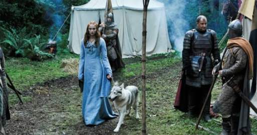 Walking with her direwolf Lady in Game of Thrones