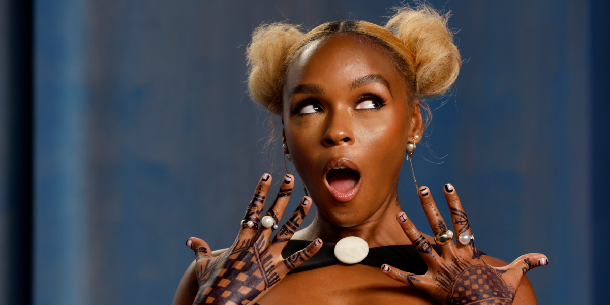 Janelle Monáe, who came out as nonbinary, with a surprised look on her face with her hairstyle in two blonde afro puffs. Janelle Monáe's Art