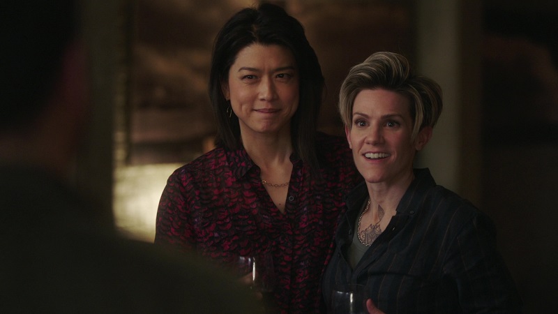Katherine and Greta smile (while holding glasses of wine) as Gary spots them at Gina and Rome's Game Night.