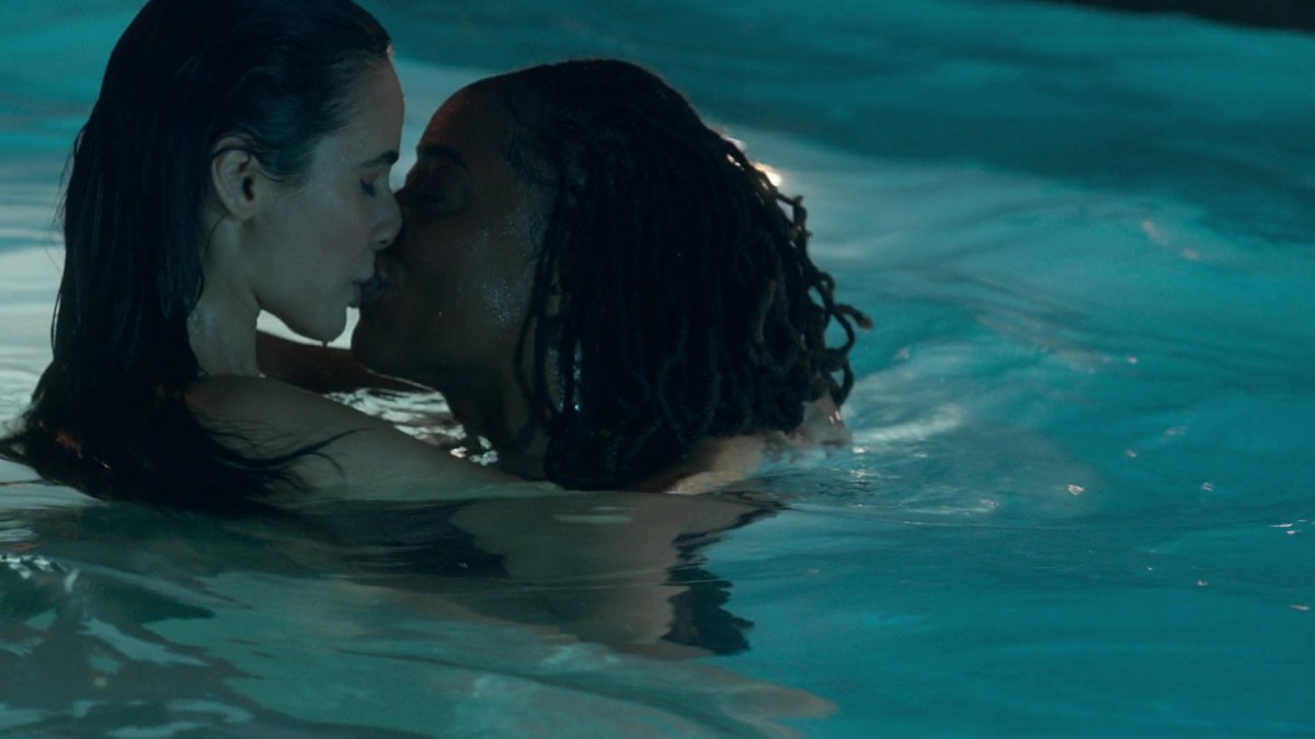 Malika and Angelica share a kiss in the Coterie pool.
