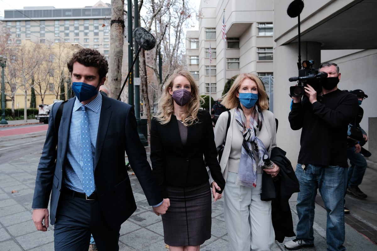 SAN JOSE, CA - DECEMBER 23: Billy Evans walks with his partner Theranos founder and former CEO Elizabeth Holmes and her mother Noel Holmes as they leave the Robert F. Peckham Federal Building on December 23, 2021 in San Jose, California. Jury deliberations continue in the Elizabeth Holmes fraud trial as she faces charges of conspiracy and wire fraud for allegedly engaging in a multimillion-dollar scheme to defraud investors with the Theranos blood-testing lab services. (Photo by David Odisho/Getty Images)