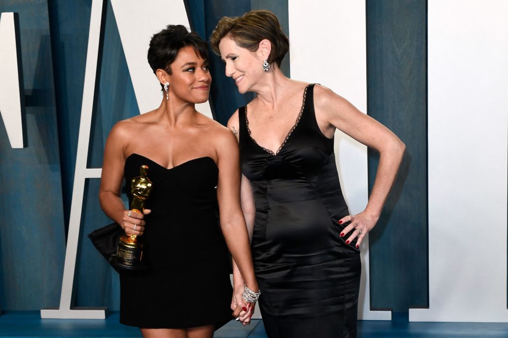 US actress Ariana DeBose, with the award for Best Actress in a Supporting Role for her performance in "West Side Story", poses with Sue Makkoo as they attends the 2022 Vanity Fair Oscar Party following the 94th Oscars. They are both wearing black dresses.