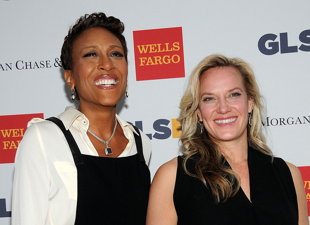 TV anchor Robin Roberts and Amber Laign attends 11th Annual GLSEN Respect awards at Gotham Hall. Robin is wearing a black jumper over a white collared shirt and smiling. Amber is wearing a black dress and smiling.