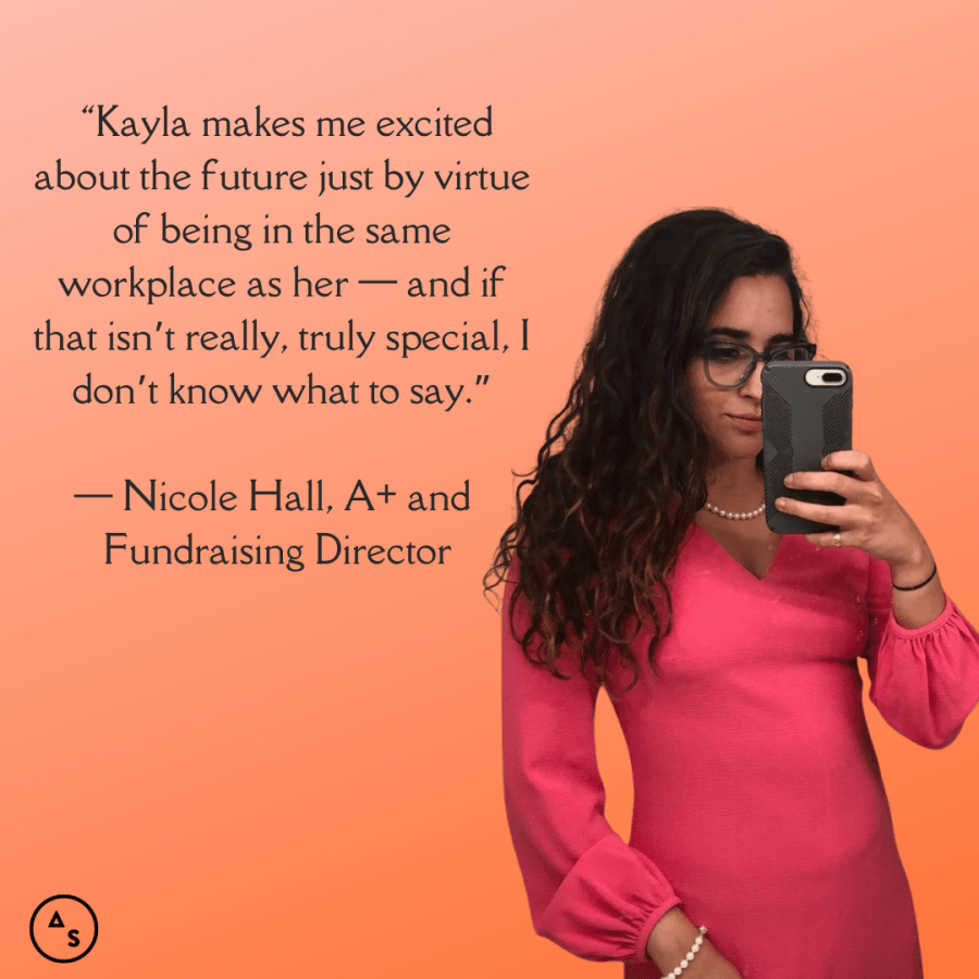 Kayla Kumari takes a poutie selfie in a pink dress in front of an orange background. In front of the background is this text: “I’m lucky that I get to be inspired by Kristen Arnett EVERY DAY. And in fact, I’m probably out somewhere being a visible lesbian with her right now as you read this.” — Nicole Hall