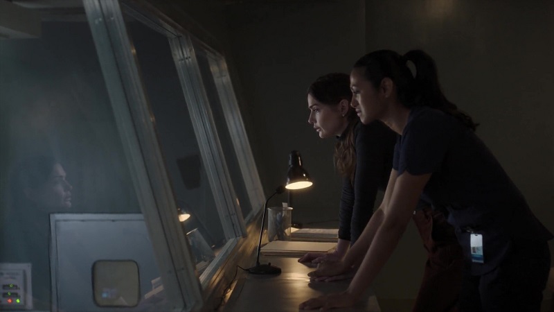 Lauren and Leyla watch Casey's surgery from the observation deck. Leyla puts her left hand on Lauren's to comfort her.