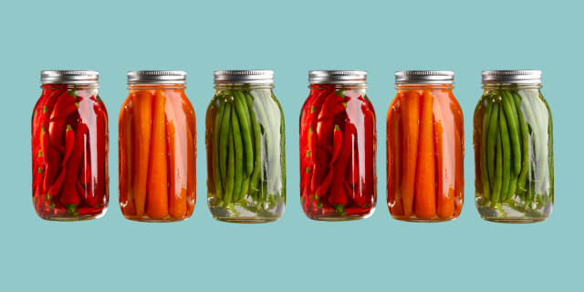 Mason jars full of carrots, green beans, and peppers