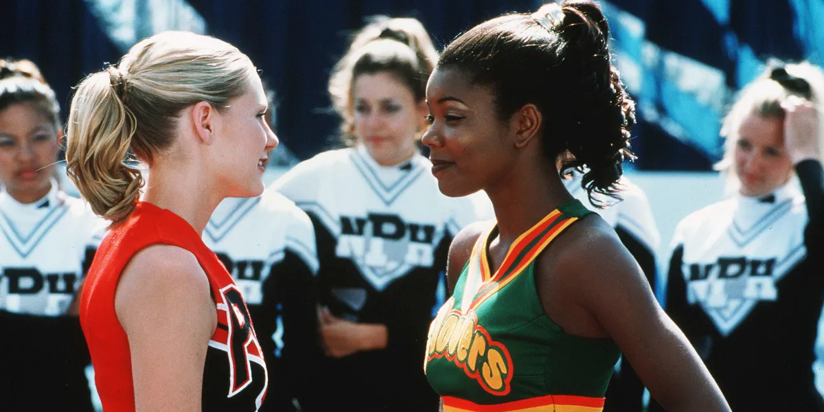 Gabrielle Union and Kiersten Dunst stare at each other in a still from Bring It On