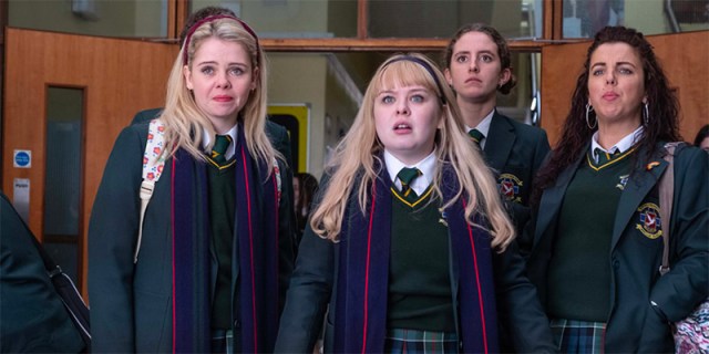 The four Derry Girls in their uniforms looking shocked