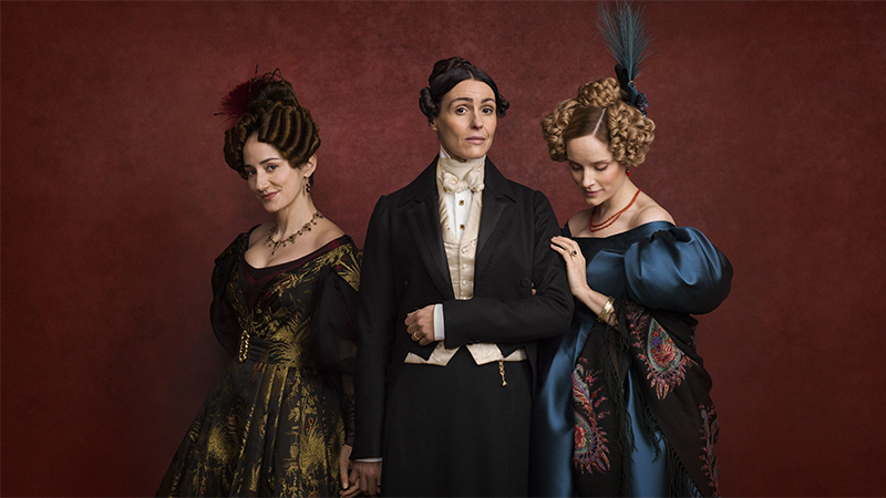 Anne Lister and Ann Walker and Mariana Lawton in period costumes against a red background