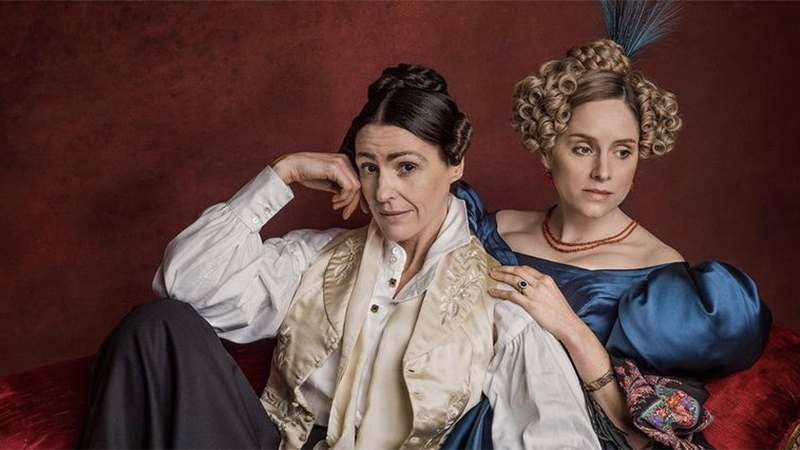 Anne Lister and Ann Walker in period costumes against a red background