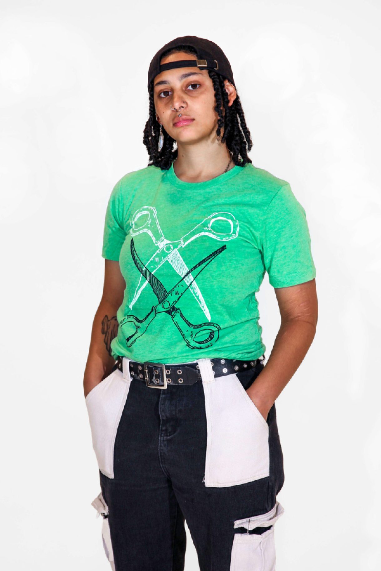A model is wearing the Basic Scissoring Green Tee in size small
