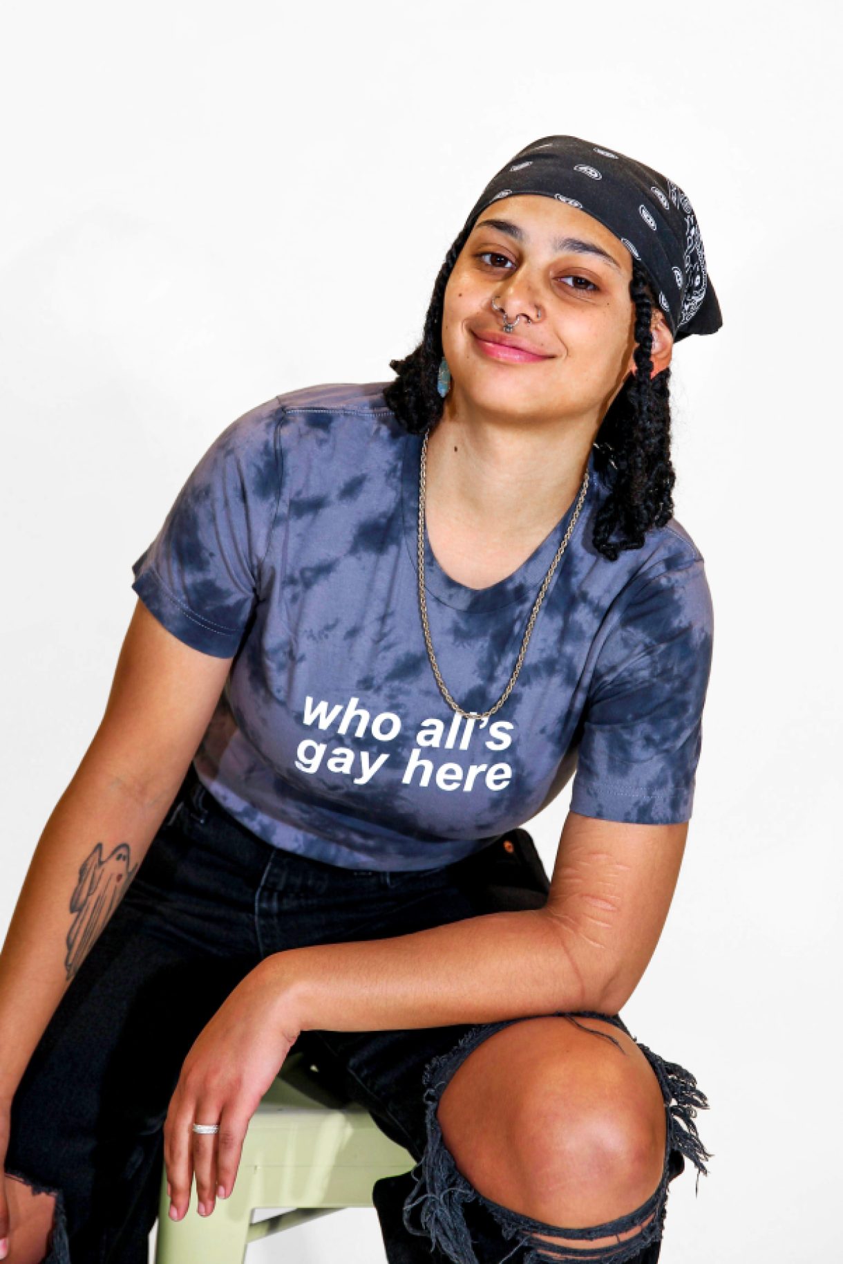 A model is wearing the Who's All Gay Here Tie-Dye Tee in size small