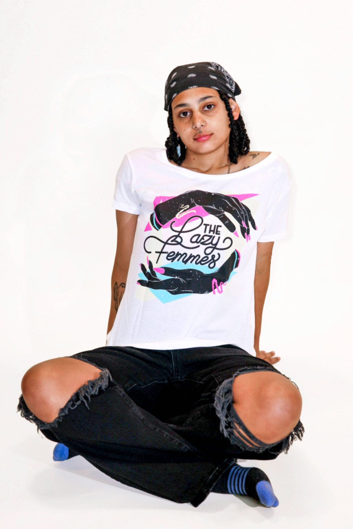A model is wearing the Lazy Femmes  Band Tee in size medium