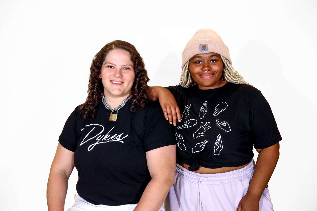 2 models wearing t-shirts from the merch store.