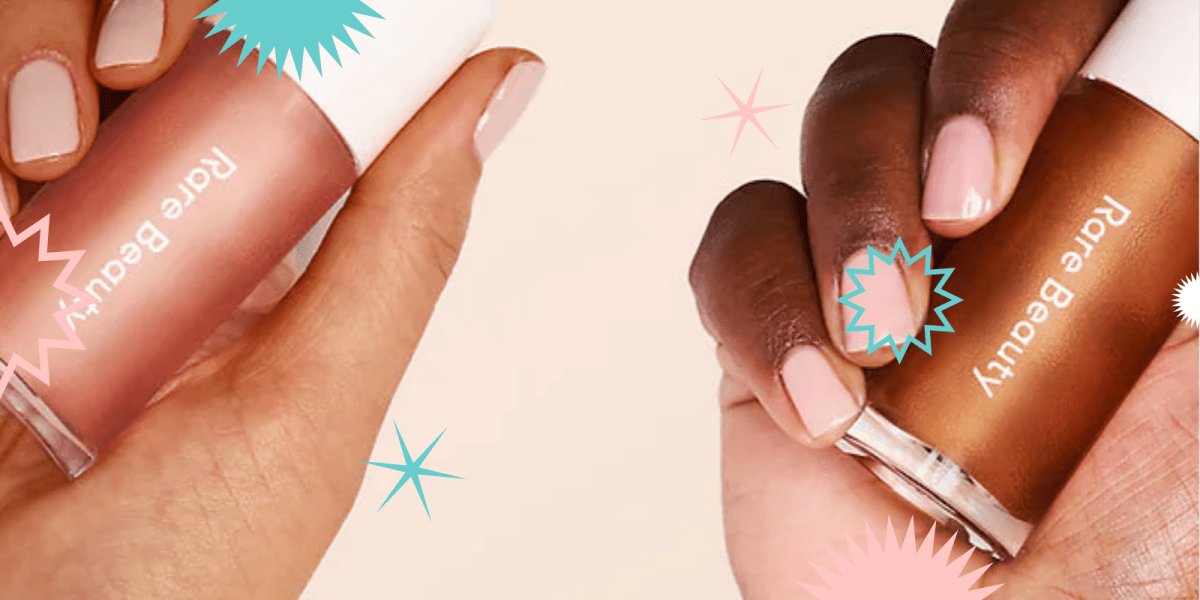 A light brown hand holds a tube of Rare Beauty Positive Light Liquid Luminizer in a rosey shade and a medium brown hand holds a tube of Rare Beauty Positive Light Liquid Luminizer in a bronzey color