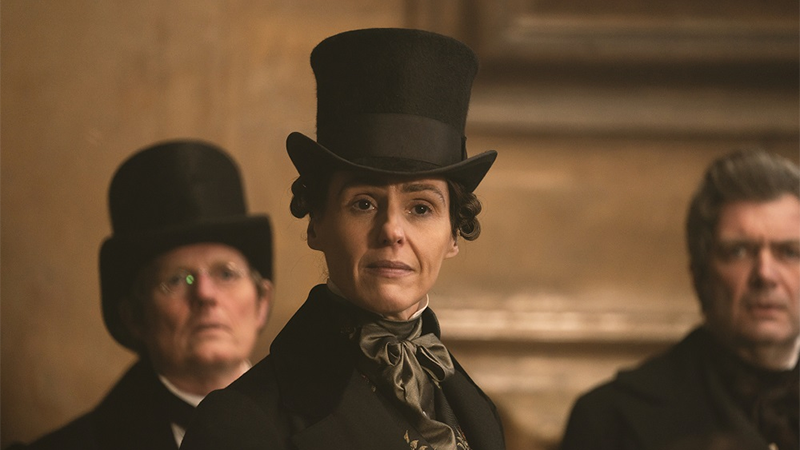 Anne Lister, in her top hat, smirks at the yelling man