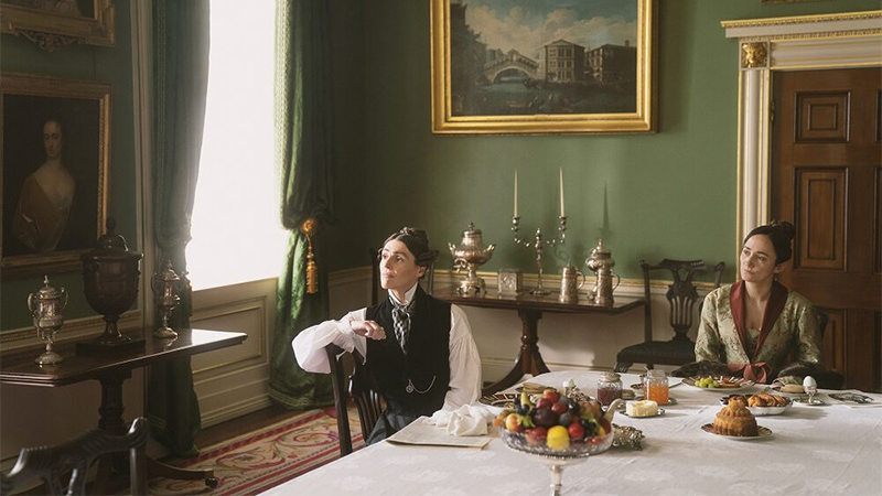 Anne and Mariana sit in a luxurious dining room