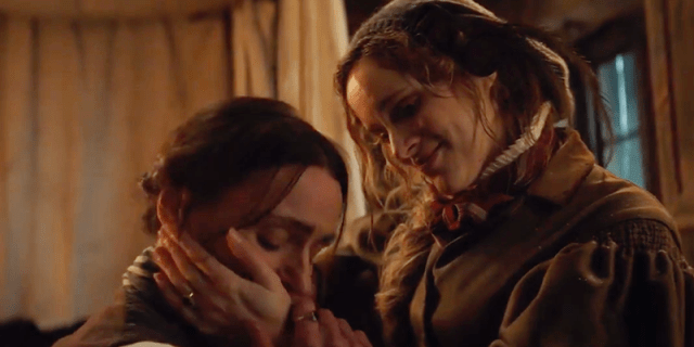 Anne Lister kneels in front of Ann Walker and kisses her hand