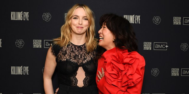 Sandra Oh laughs at Jodie Comer, who tries to keep a straight face, on the Killing Eve red carpet