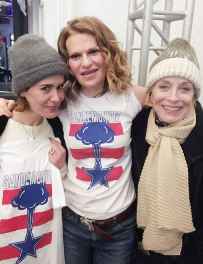 Sarah Paulson, Sandra Bernhard, and Holland Taylor post for a photo. Sarah and Sandra are wearing shirts for Sandra's Broadway show Sandemonium. Holland is wearing a wool beanie and a large tan scarf.
