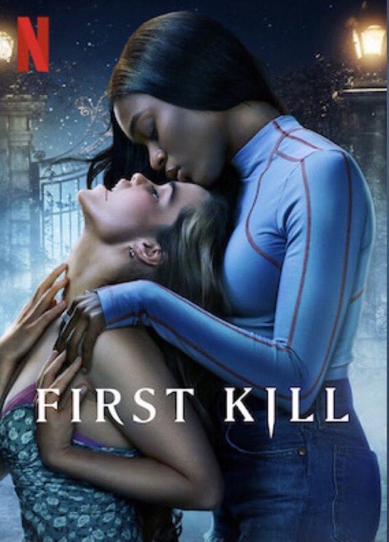 In a poster of First Kill from Netflix, it is night and two lesbian vampires are holding each other with the shorter vampire, a white teen with blonde hair, is holding hands with her back to a second vampire, a black teenager with long black hair. The teens have their mouths opens showing their fangs, as they are about to kiss.