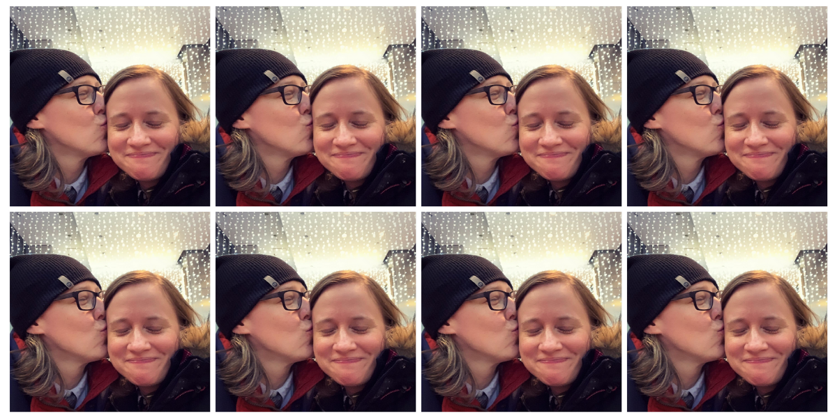 Heather and Stacy are pictured in photo repeated eight times in a grid pattern. In the photo, Heather, a soft butch white woman wearing black rimmed glasses and a beanie, kisses Stacy, a white woman with light brown hair, on the cheek. They are both smiling and both look happy. You can see string lights glowing behind them..
