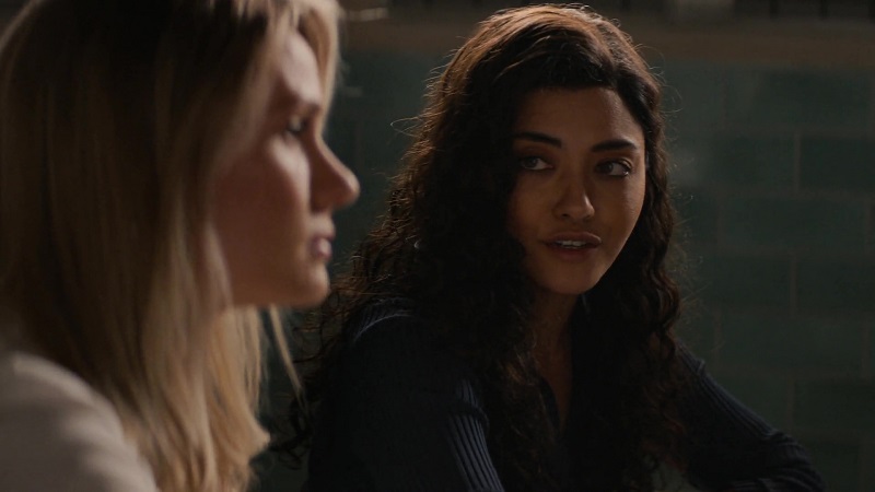 Lucy looks over at Kate, as she interrogates a suspect.