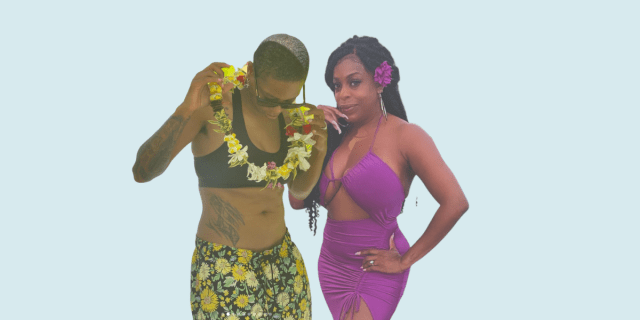 Jessica Betts wears floral swim trunks and a black sports bra and a lei. Niecy Nash wears a magenta mini dress with cutouts and a flower in her hair.