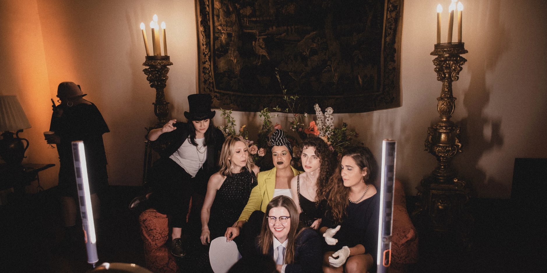 Autostraddle team and guests posing at an 1800s-style photobooth