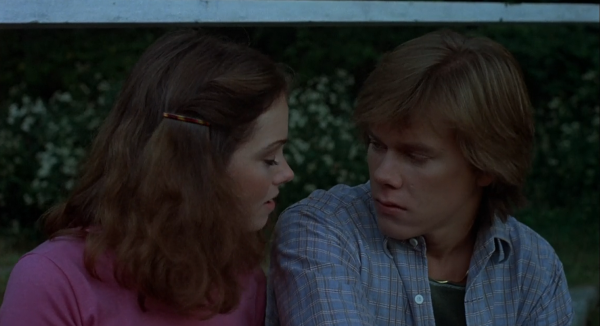 Jeannine Taylor and Kevin Bacon talk to each other on a cabin porch in Friday the 13th