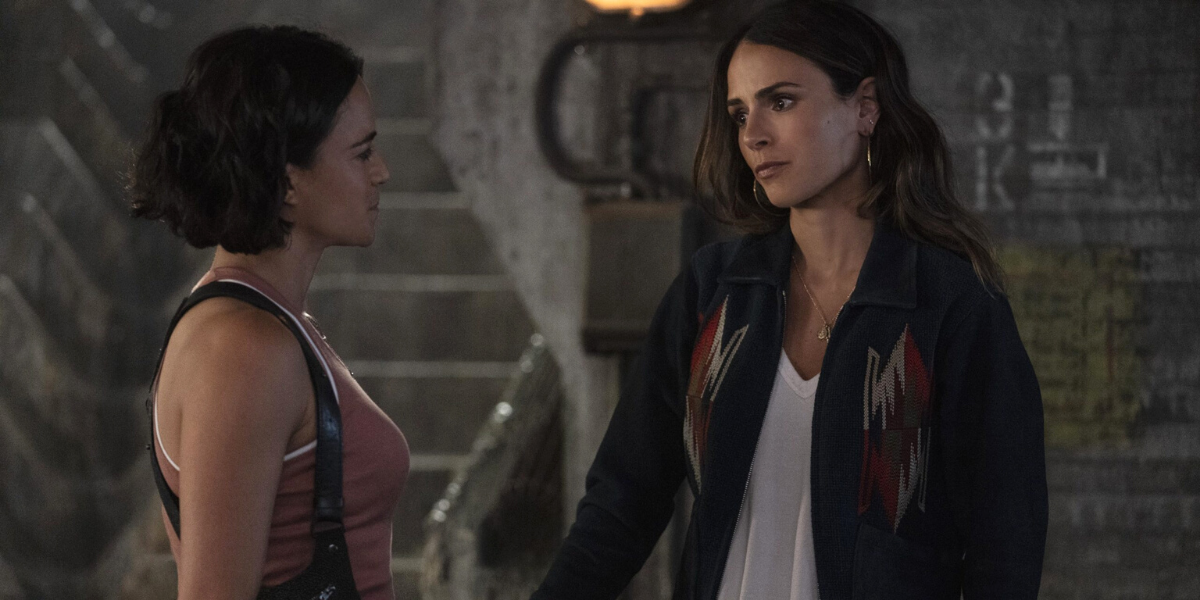 Letty Ortiz (Michelle Rodriguez) and Mia Toretto (Jordana Brewster) in the Fast & Furious franchise hold hands while looking into each other's eyes.