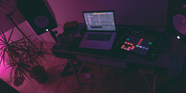 A makeshift recording studio with a laptop and a beats machine
