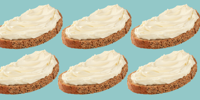 A piece of multigrain bread has spreadable white soft cheese on top of it. The image is repeated six times against a blue background.