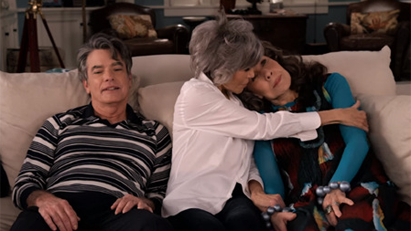 Nick sits on the couch alone while Grace hugs Frankie