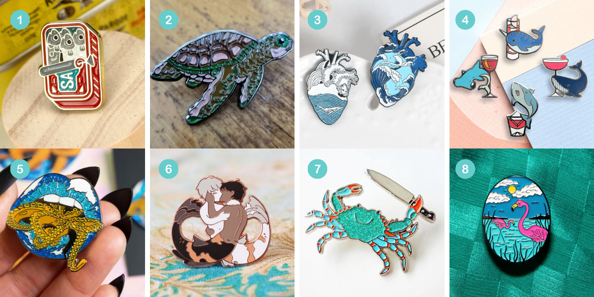 Photo 1: An enamel pin shaped like a tin of sardines. Photo 2: An enamel pin shaped like a sea turtle. Photo 3: Two enamel pins shaped like anatomical hearts with oceans inside of them. Photo 4: An enamel pin shaped like a hammerhead shark with a glass of aperitif, an enamel pin shaped like a narwhal with a cocktail, an enamel pin shaped like a great white shark with a negroni, and an enamel pin shaped like a whale with a martini. Photo 5: An enamel pin shaped like a mouth with blue lipstick with tentacles emerging between the teeth. Photo 6: An enamel pin shaped like two merpeople embraced in a kiss. Photo 7: A sparkly enamel pin shaped like a crab holding a knife. Photo 8: An enamel pin depicting two flamingos walking in water with a sun behind them.