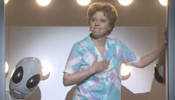 Kate McKinnon holds her hand over her heart in her final alien abduction sketch on SNL