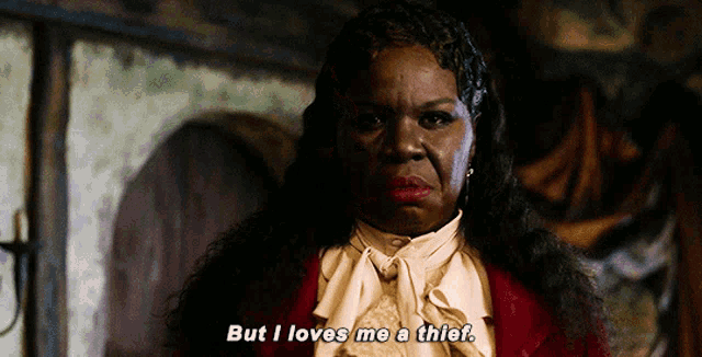 Leslie Jones in her pirarte suit says "But I love me a thief." 