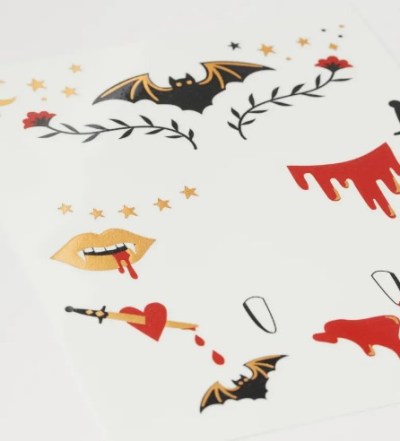 several spooky temporary tattoos from H&M featuring designs such as bats, thorny roses, and bloody vampire fangs