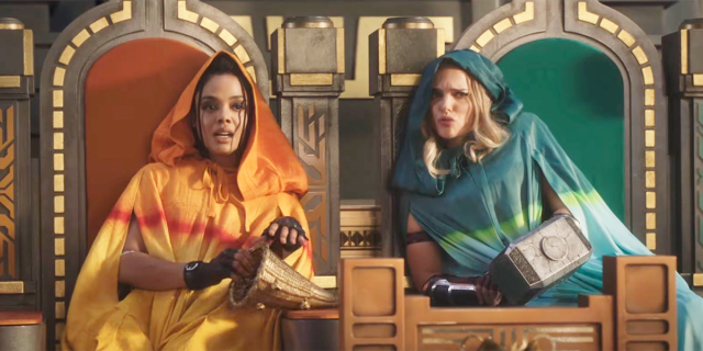 Valkyrie and Jane sit together in colorful cloaks on thrones in Thor: Love and Thunder