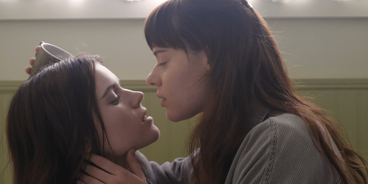 Two girls face to face nearly kissing