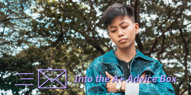 a young lesbian woman stands pensively in front of a bunch of trees. She has her arms folded and is wearing a jean jacket. Text on the image reads "Into the A+ Advice Box"