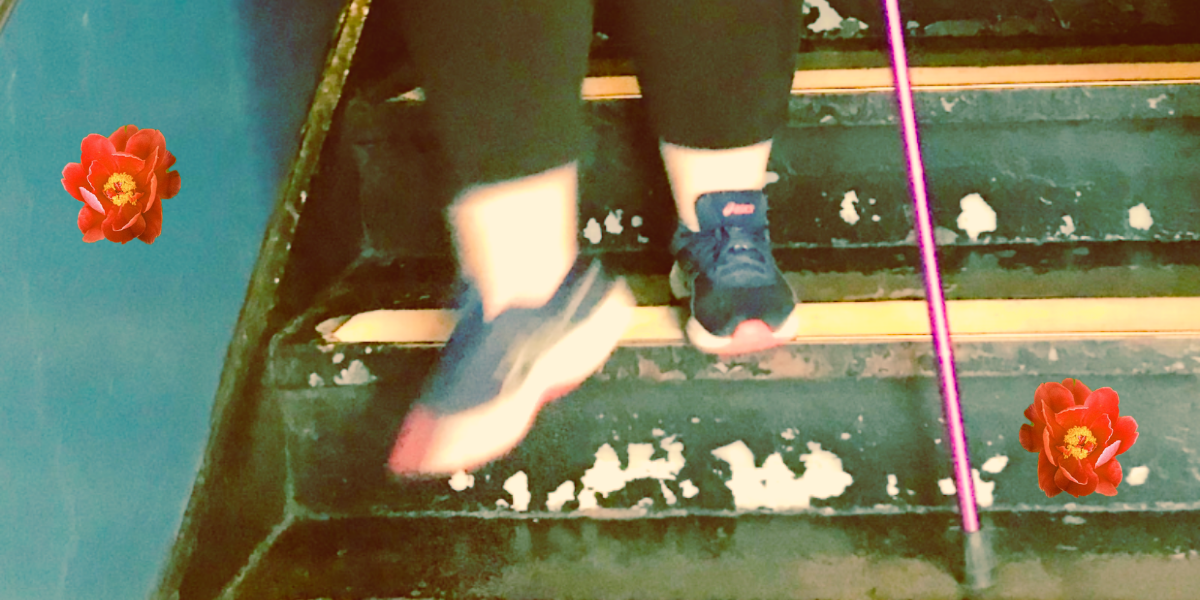 a white person's legs are seen walking down a set of old stairs, and she is wearing sneakers and holding a pink cane and wearing black leggings. there are two red flower stickers on the image