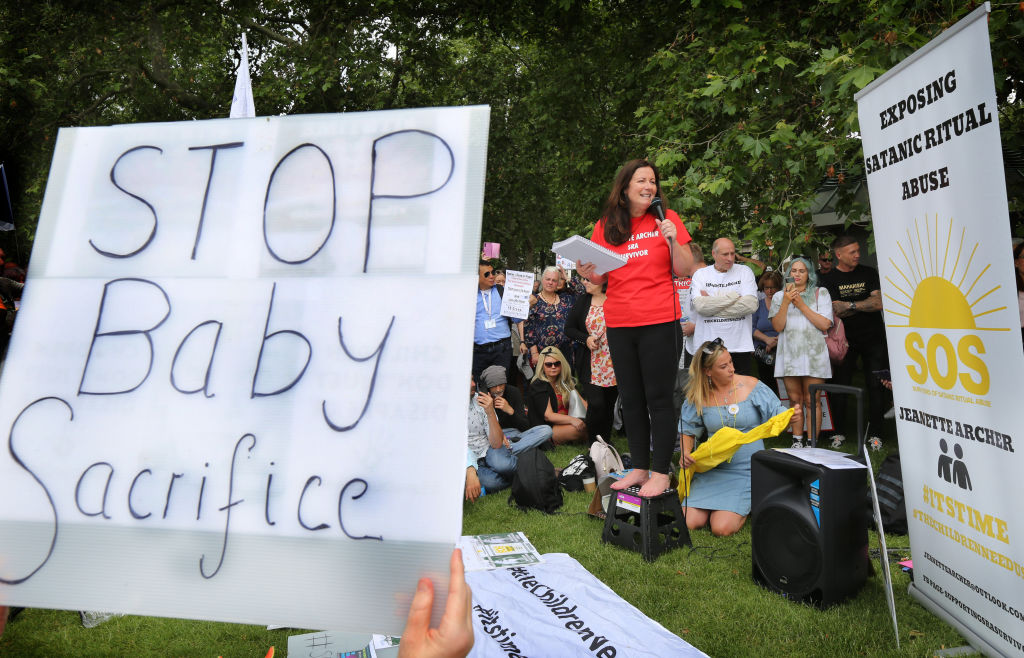 HYDE PARK, LONDON, UNITED KINGDOM - 2021/06/26: A 'Stop Baby Sacrifice' placard held by a protester during the demonstration. Protesters gather together in Hyde Park, London to expose Satanic Ritual Abuse. The group want to bring this type of child abuse into the open and expose high ranking Satanists that they say hold powerful positions in the UK. (Photo by Martin Pope/SOPA Images/LightRocket via Getty Images)